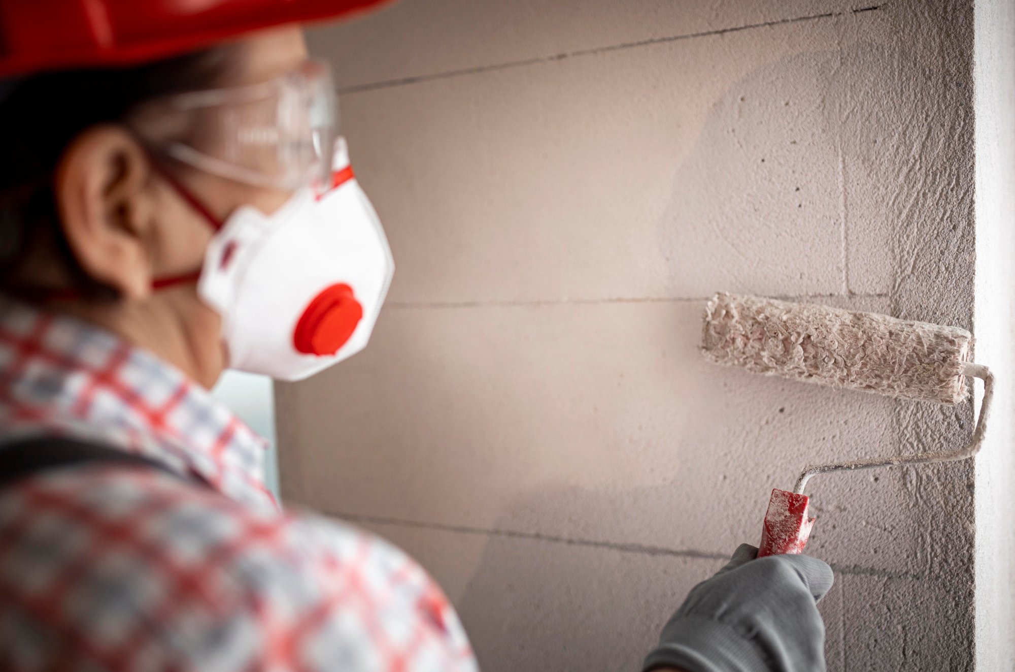 back-view-female-construction-worker-with-helmet-paint-roller